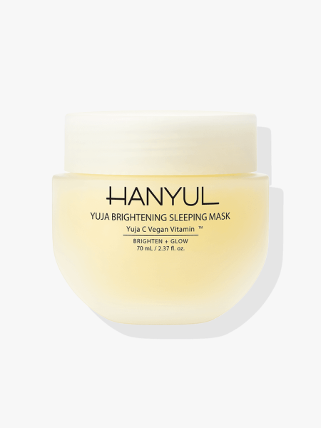 A yellow tub of Hanyul Yuja Brightening Sleeping Mask on a light gray background